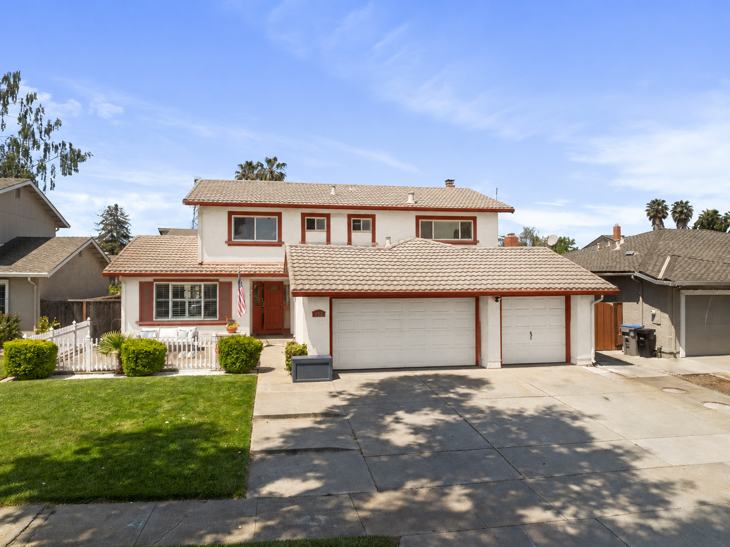 Warm white exterior paint mockup with reddened earth trim